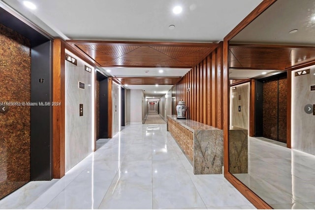 hallway with wood walls