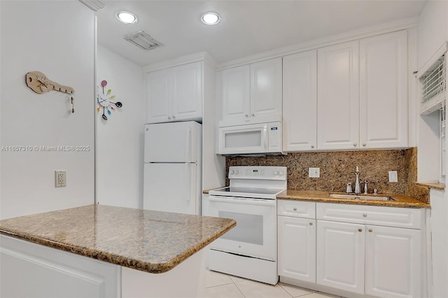 kitchen with white cabinetry, sink, light tile patterned floors, and white appliances