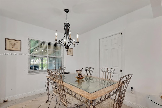 tiled dining room featuring a notable chandelier