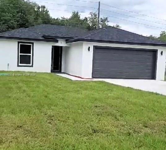 exterior space featuring a front lawn and a garage