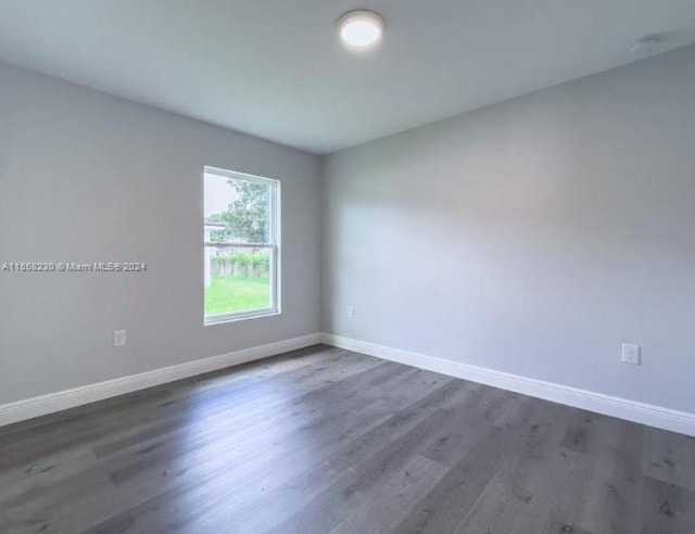 unfurnished room featuring dark hardwood / wood-style flooring