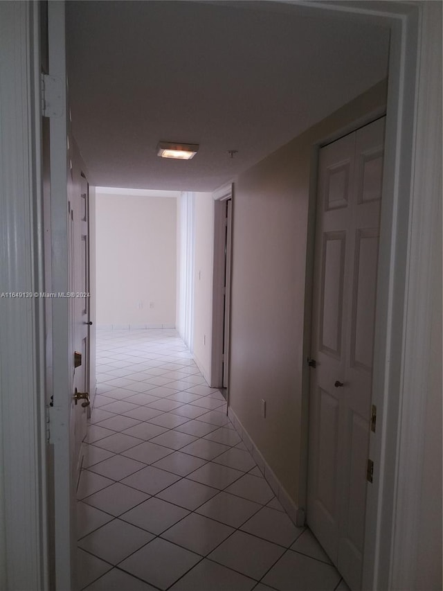 hallway featuring light tile patterned floors