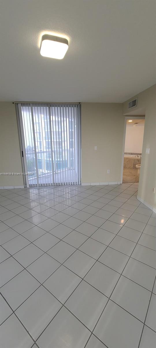 unfurnished room with light tile patterned floors