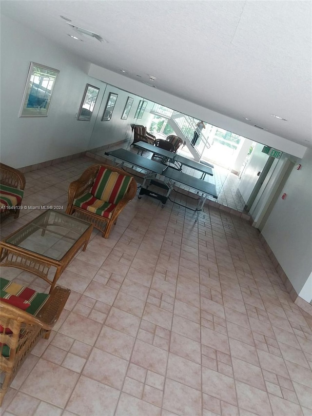 living room with a skylight and light tile patterned floors