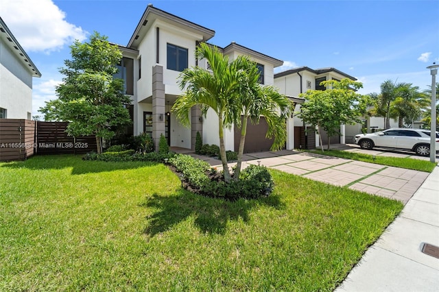 view of front of property featuring a garage and a front yard