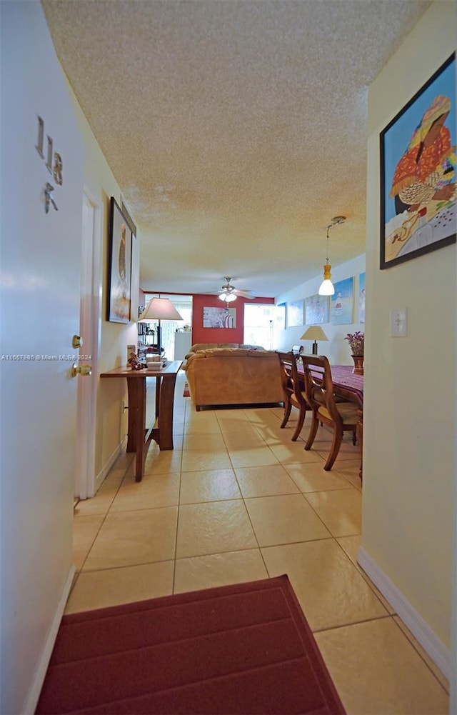 17560 Atlantic Blvd Unit 118, Sunny Isles Beach, FL 33160 - hallway with a textured ceiling, light tile patterned floors, and baseboards