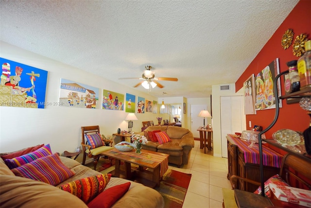 living room featuring a textured ceiling, ceiling fan, and light tile patterned floors