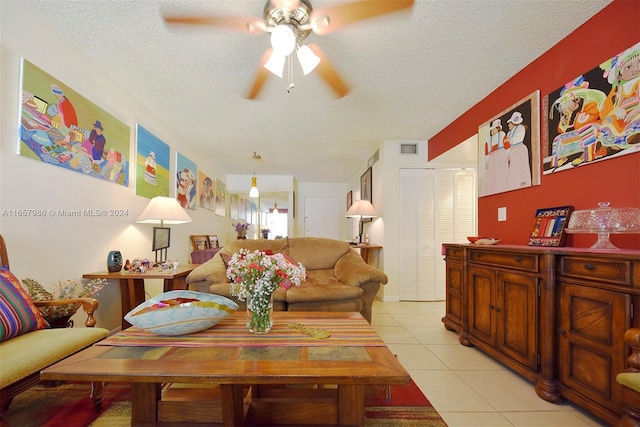 tiled living room featuring a textured ceiling and ceiling fan