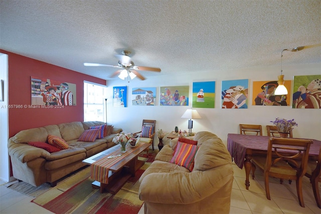 living room featuring tile patterned floors, ceiling fan, and a textured ceiling