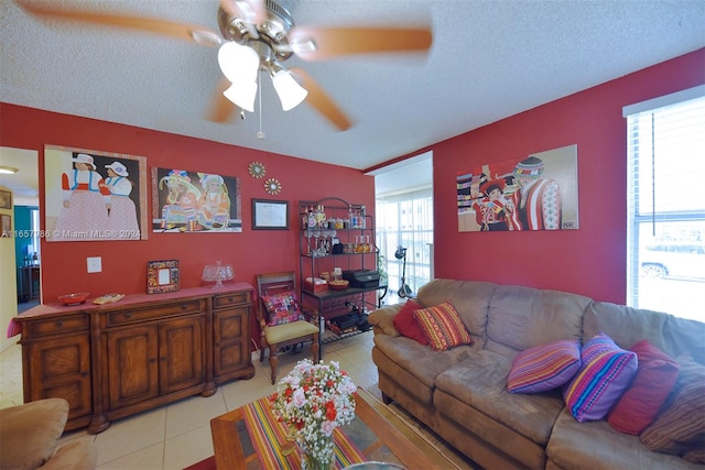 tiled living room featuring ceiling fan and a textured ceiling