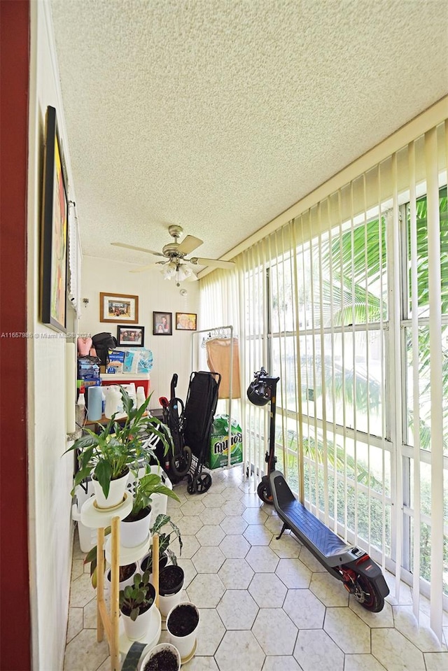 sunroom featuring ceiling fan