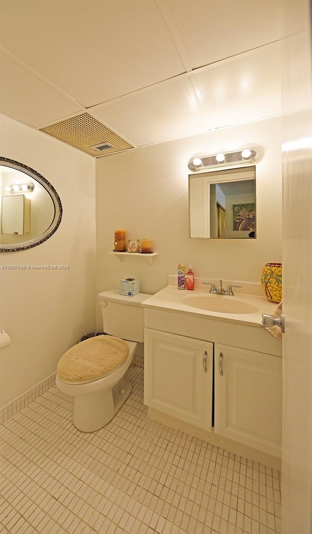 bathroom with vanity, toilet, and tile patterned floors