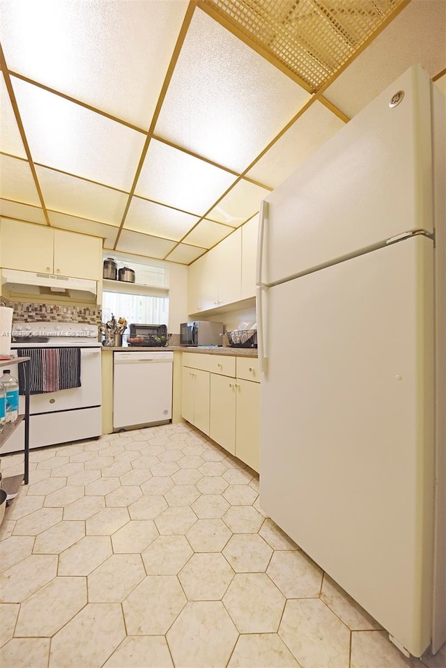 kitchen featuring white appliances and white cabinets