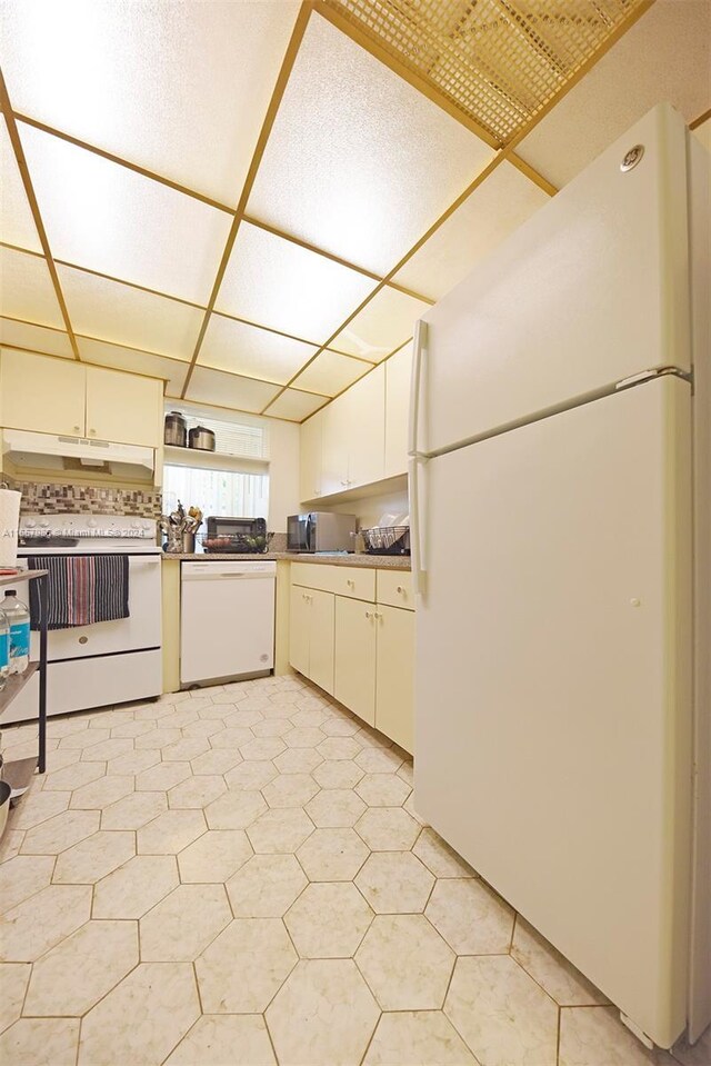 17560 Atlantic Blvd Unit 118, Sunny Isles Beach, FL 33160 - kitchen featuring white appliances, under cabinet range hood, white cabinets, and decorative backsplash