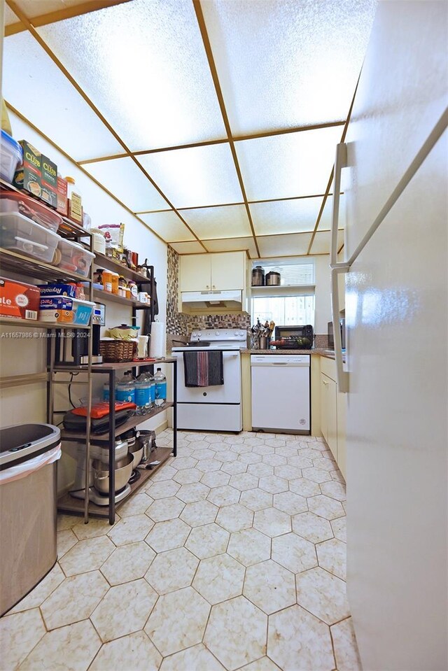 17560 Atlantic Blvd Unit 118, Sunny Isles Beach, FL 33160 - kitchen featuring white appliances, white cabinets, and under cabinet range hood