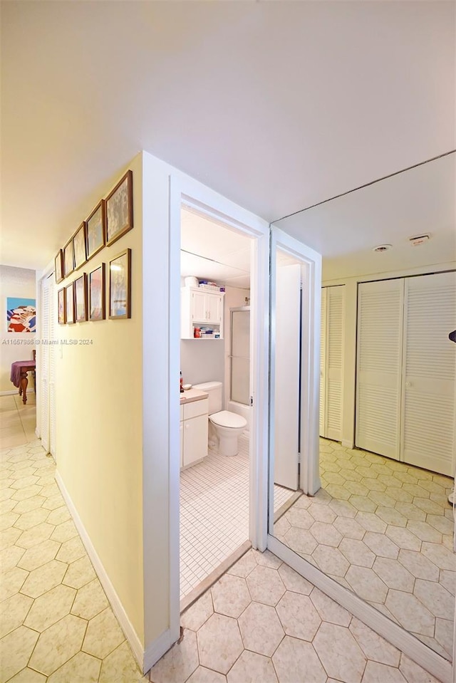 hall featuring light tile patterned floors