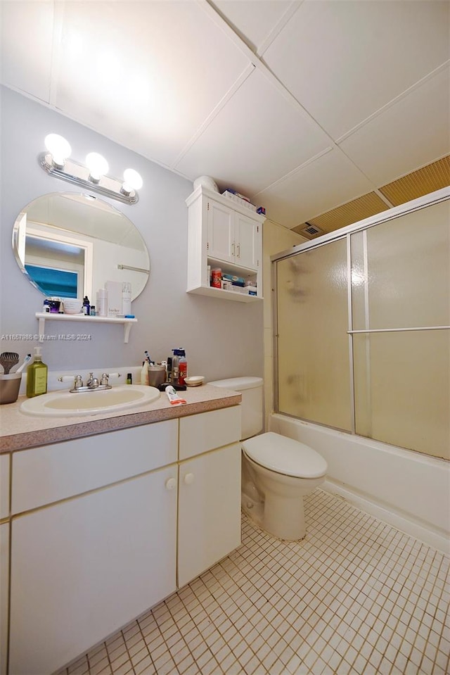 full bathroom featuring shower / bath combination with glass door, vanity, and toilet