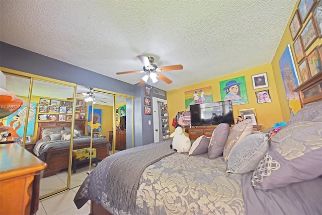 17560 Atlantic Blvd Unit 118, Sunny Isles Beach, FL 33160 - tiled bedroom with multiple closets, a ceiling fan, and a textured ceiling