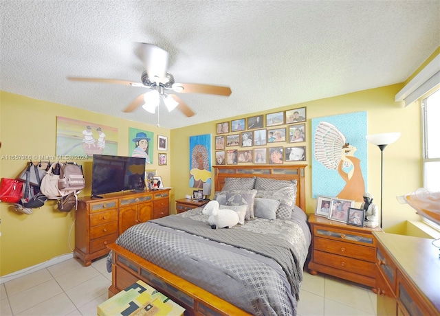 tiled bedroom featuring a textured ceiling and ceiling fan