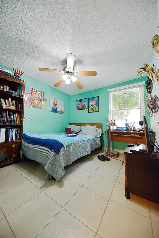 17560 Atlantic Blvd Unit 118, Sunny Isles Beach, FL 33160 - bedroom featuring a textured ceiling, tile patterned flooring, and a ceiling fan