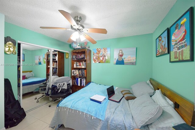 17560 Atlantic Blvd Unit 118, Sunny Isles Beach, FL 33160 - tiled bedroom featuring a textured ceiling, a ceiling fan, and a closet