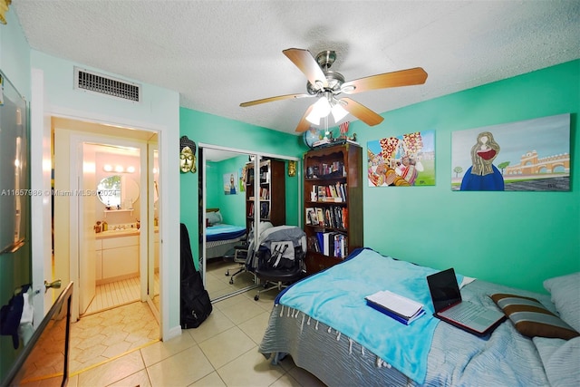 17560 Atlantic Blvd Unit 118, Sunny Isles Beach, FL 33160 - bedroom with a closet, ceiling fan, tile patterned floors, and a textured ceiling