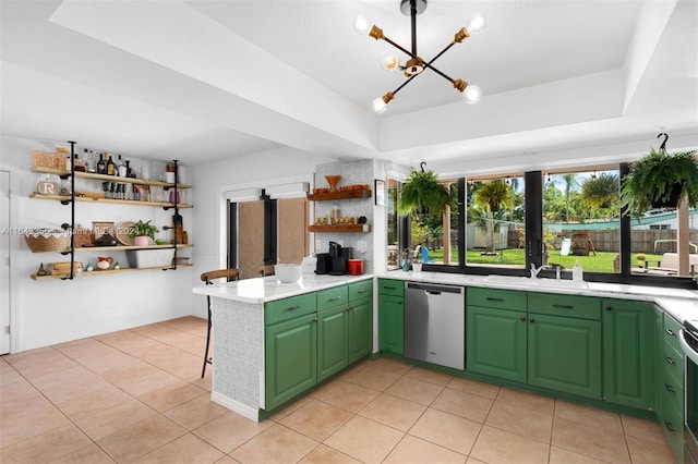 kitchen featuring appliances with stainless steel finishes, green cabinets, kitchen peninsula, sink, and light tile patterned flooring