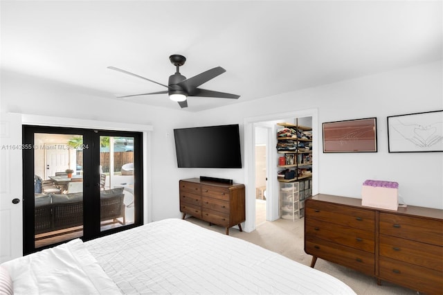 bedroom featuring a spacious closet, a closet, access to exterior, light colored carpet, and ceiling fan