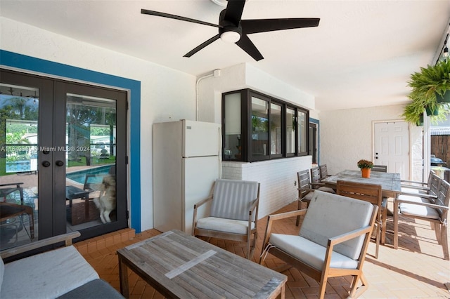 sitting room with french doors, ceiling fan, and a healthy amount of sunlight