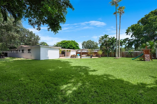 view of yard with a playground and a patio area