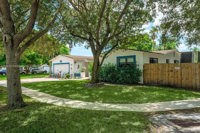 single story home featuring a garage and a front lawn