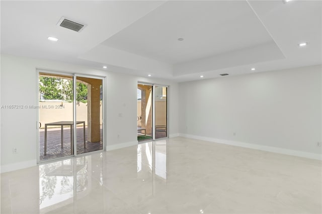 empty room featuring a tray ceiling