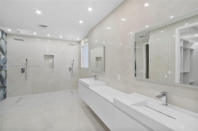 bathroom with tiled shower and vanity