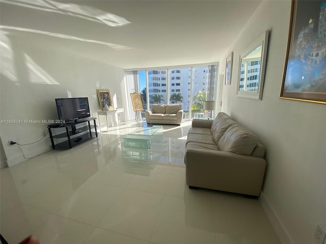 tiled living room featuring a wall of windows