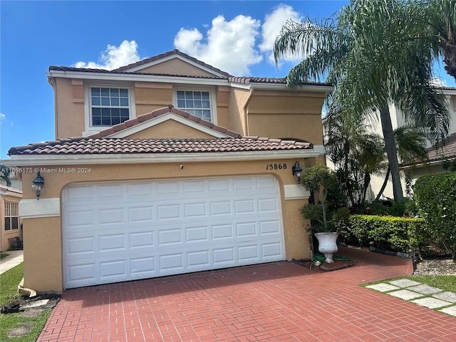 mediterranean / spanish-style home with a garage