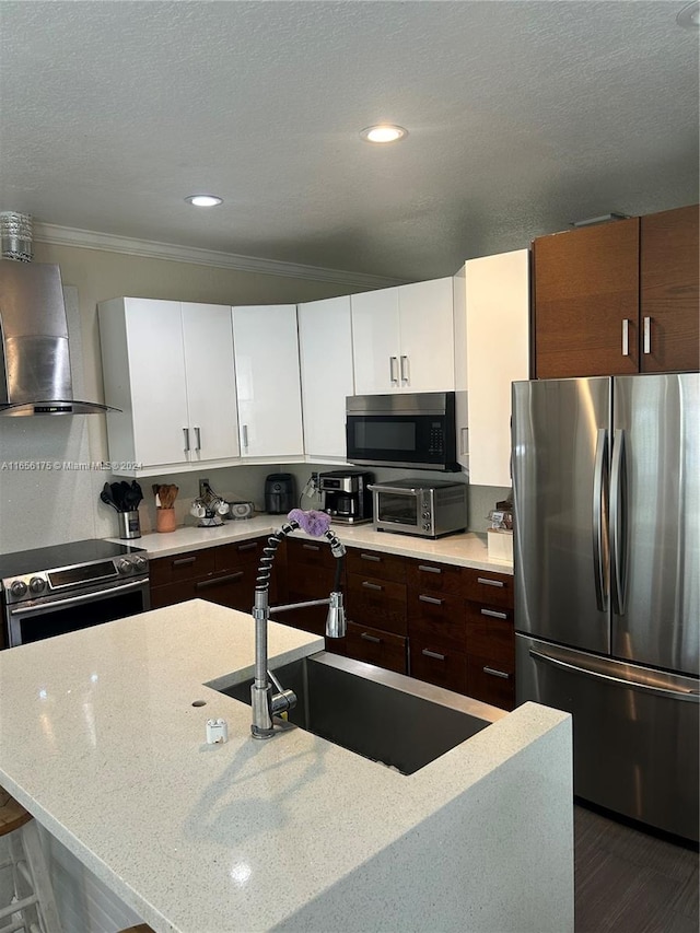 kitchen featuring dark hardwood / wood-style floors, wall chimney range hood, stainless steel appliances, and white cabinets