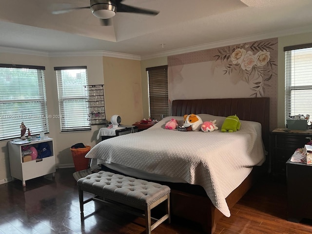 bedroom with multiple windows, wood-type flooring, ornamental molding, and ceiling fan