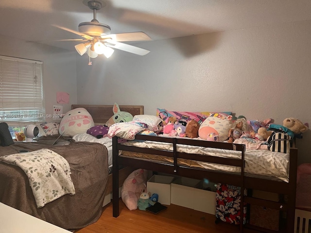 bedroom featuring hardwood / wood-style floors and ceiling fan