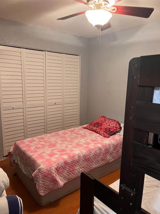 bedroom with ceiling fan and hardwood / wood-style flooring