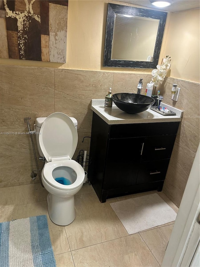 bathroom with decorative backsplash, tile walls, vanity, and toilet