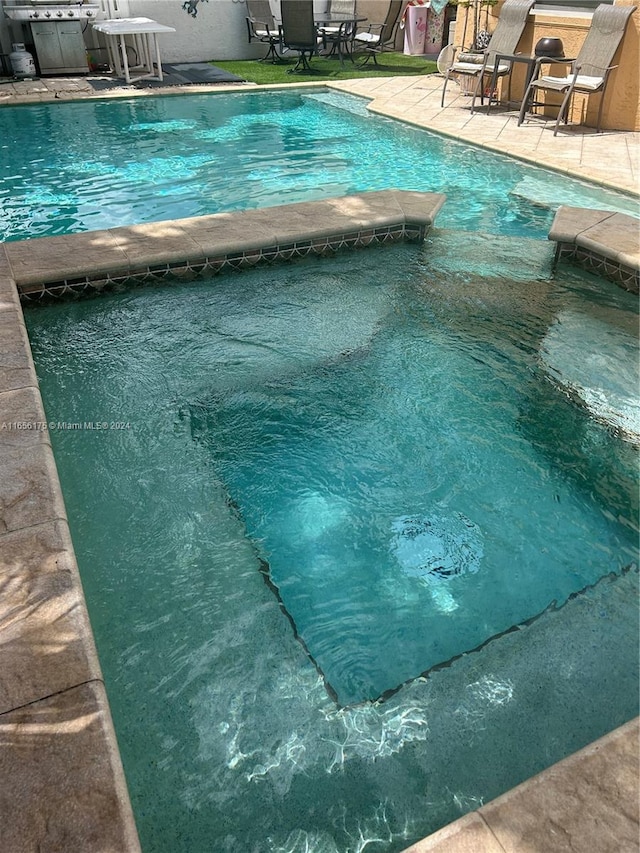 view of pool featuring a patio area