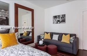 bedroom with dark wood-type flooring