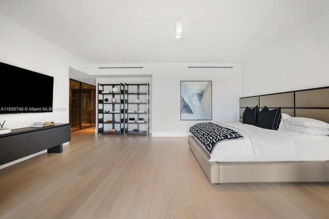 bedroom with hardwood / wood-style floors