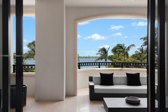 interior space featuring a water view and a balcony