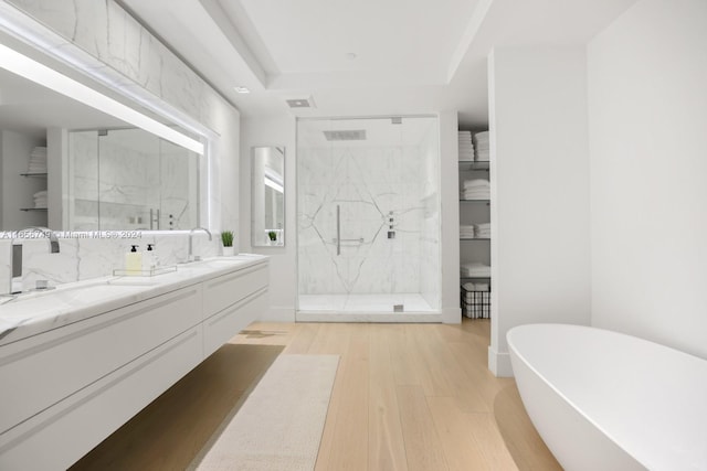 bathroom featuring separate shower and tub, vanity, and wood-type flooring