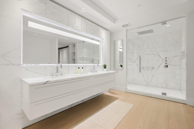 bathroom featuring hardwood / wood-style floors, vanity, and walk in shower