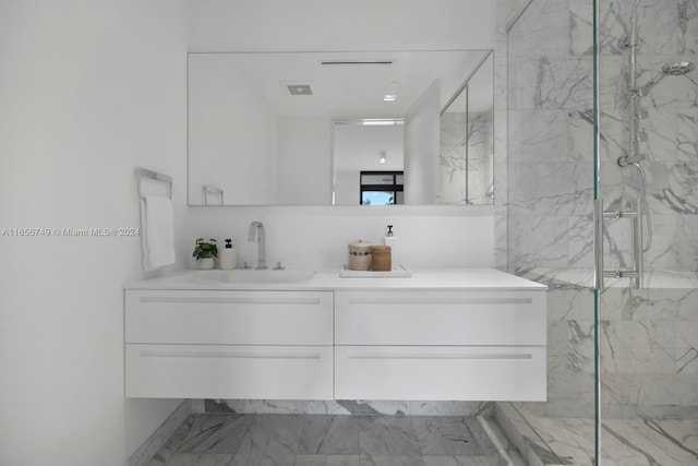 bathroom with vanity and a tile shower