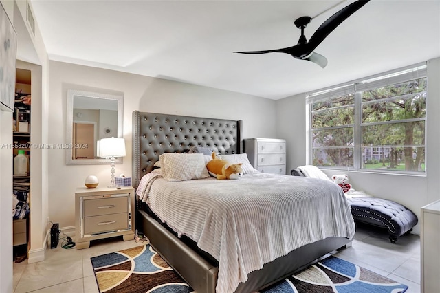 tiled bedroom with ceiling fan