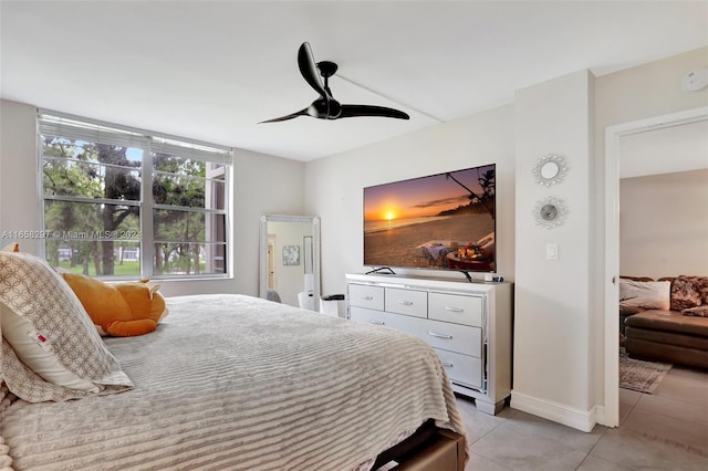 tiled bedroom featuring ceiling fan