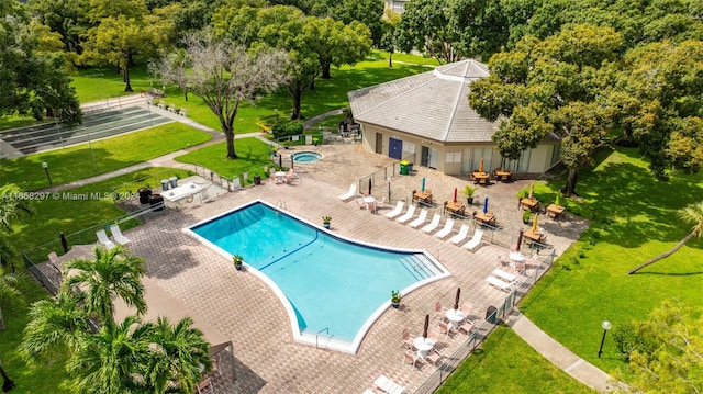 view of swimming pool with a lawn and a patio